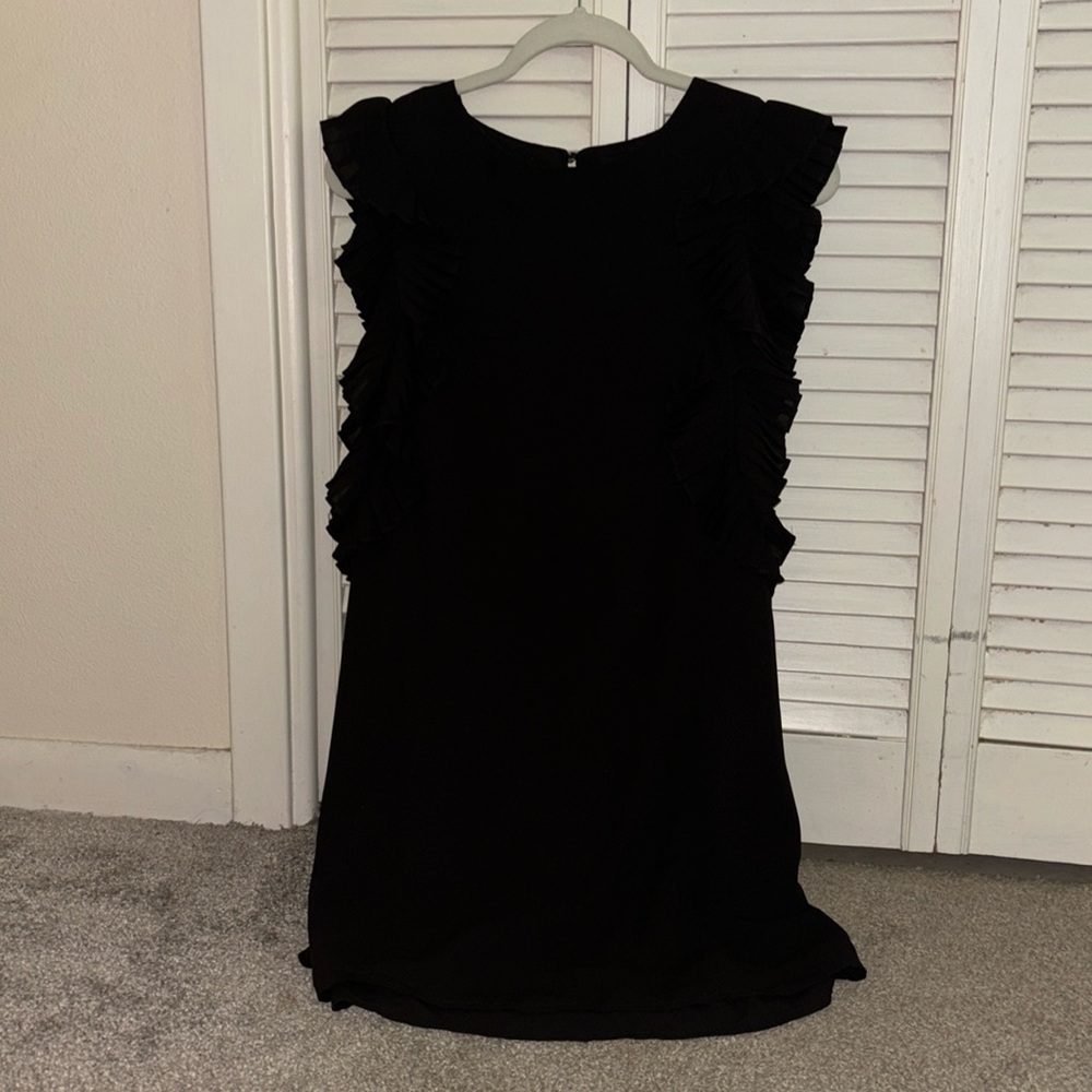 Black dress with with ruffles on the sleeves, button in the back to hook